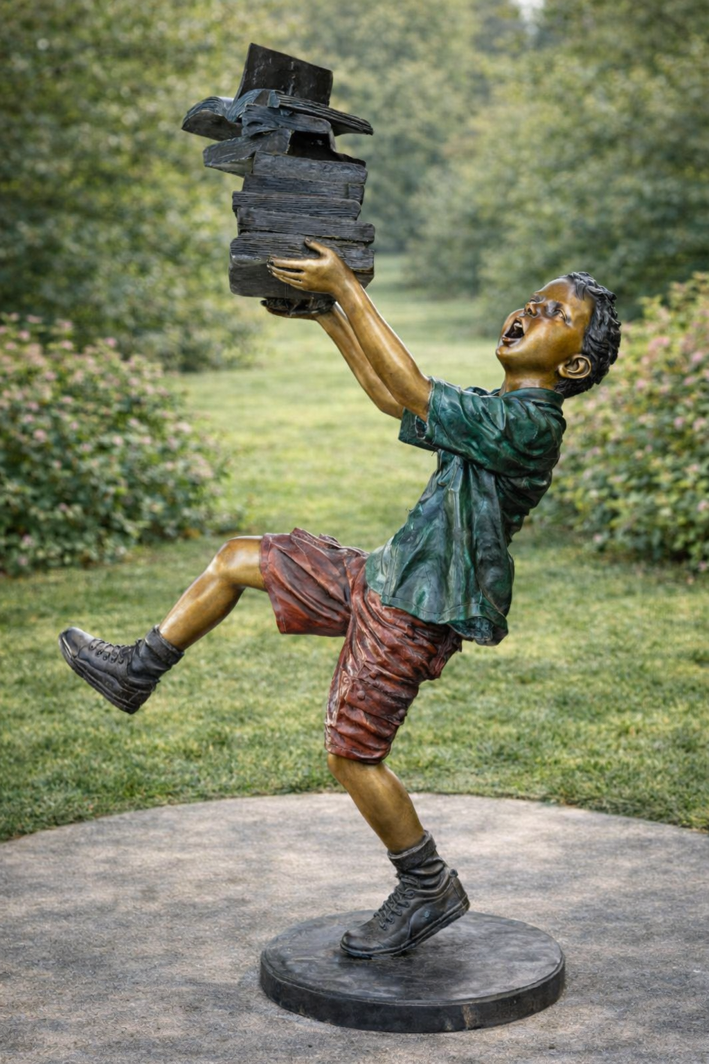 bronze boy statue with books in garden
